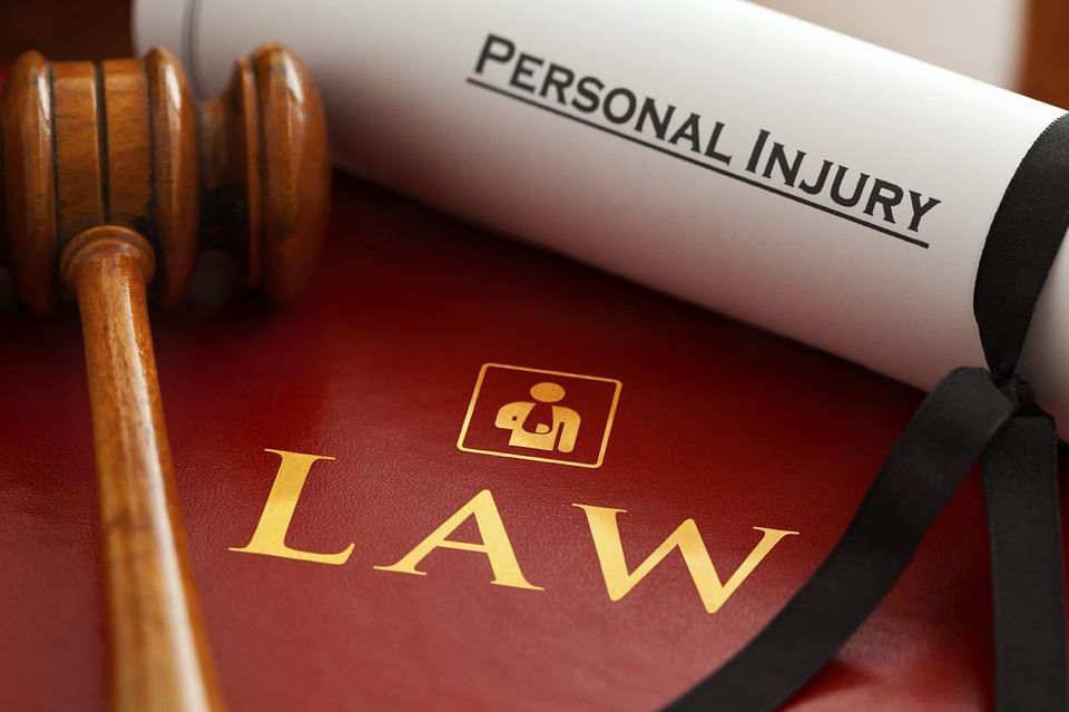 An image of a gavel, a law book, and a document about personal injury